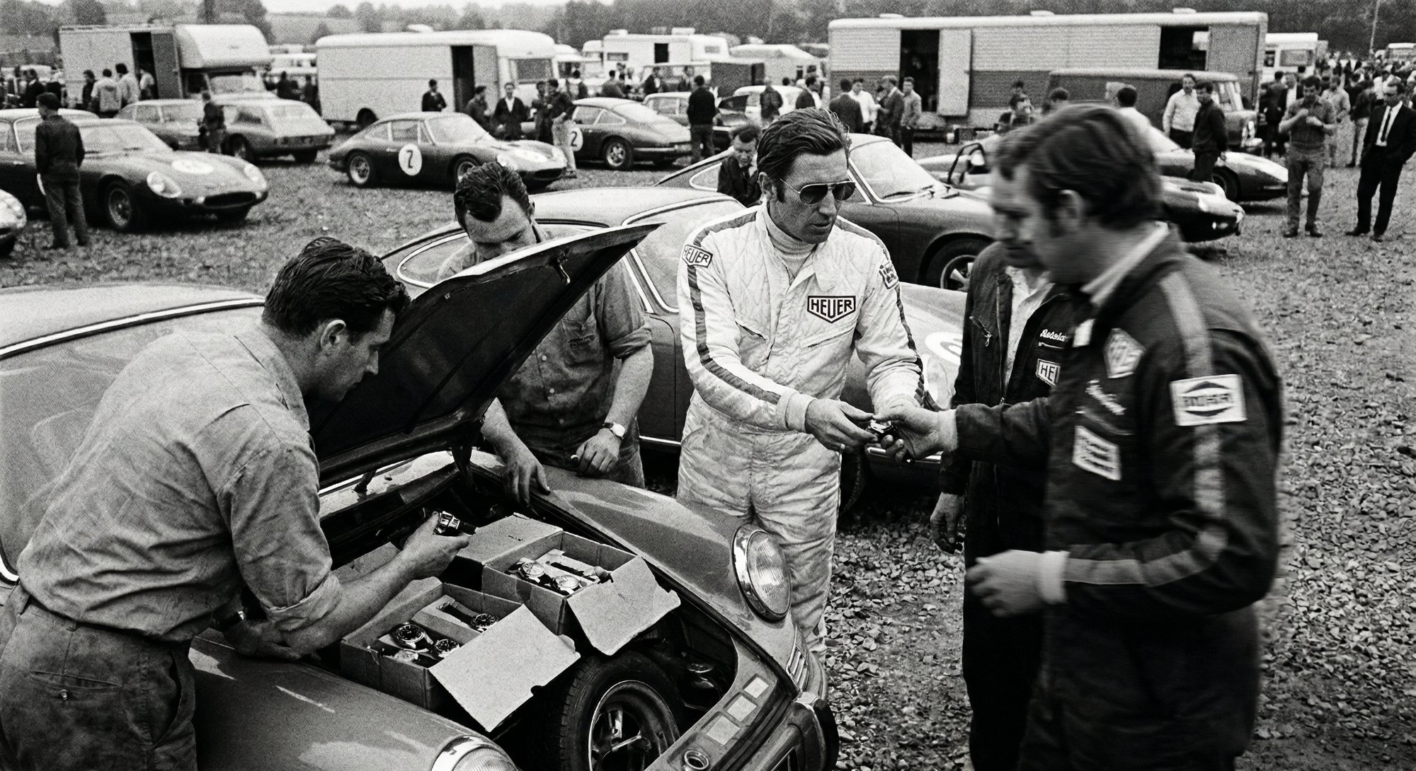 Siffert selling Heuer watches from the boot of his Porsche in the paddock